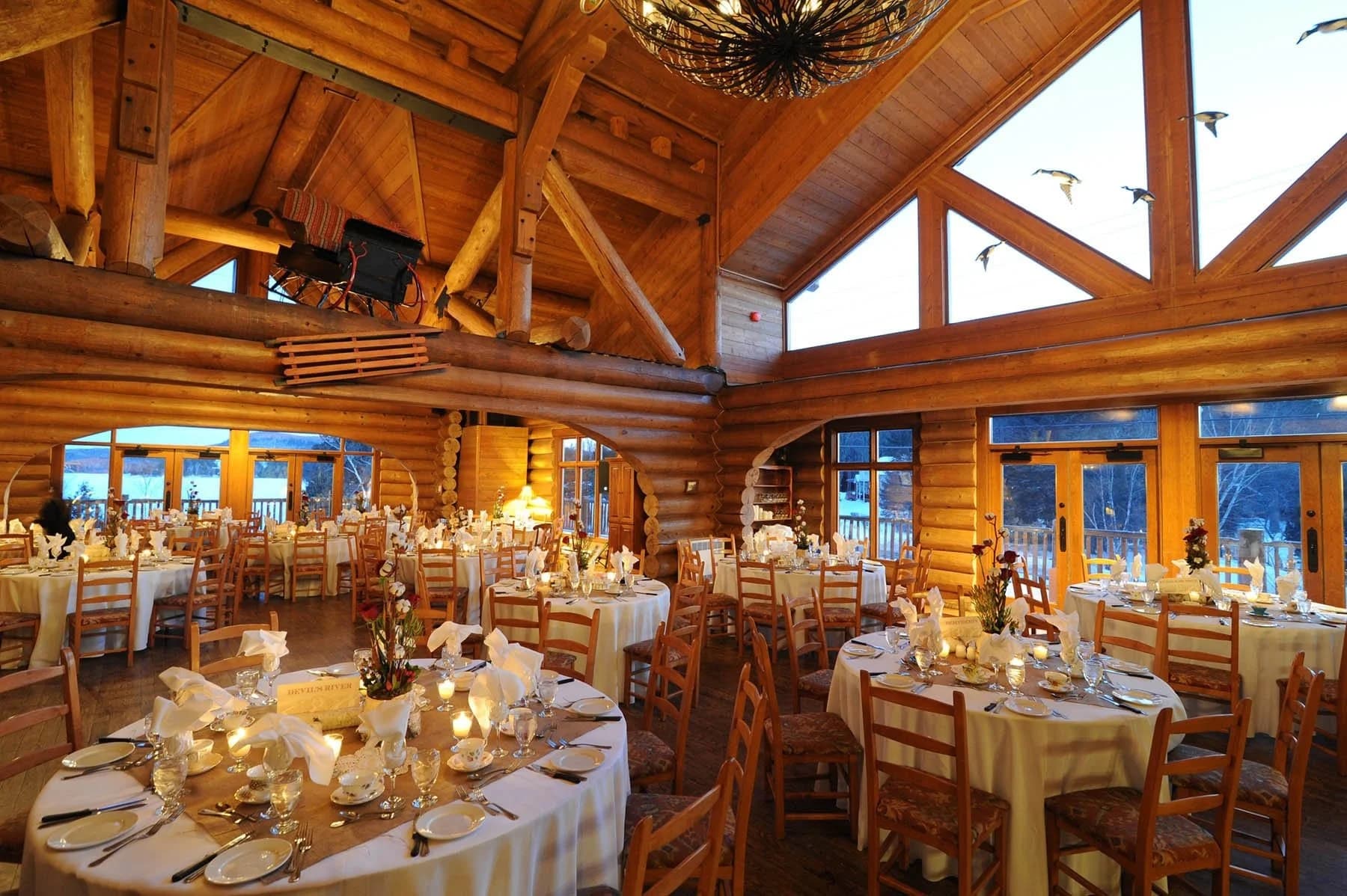 The dining hall at Le Grand Lodge Mont-Tremblant, with cathedral ceilings and forest views